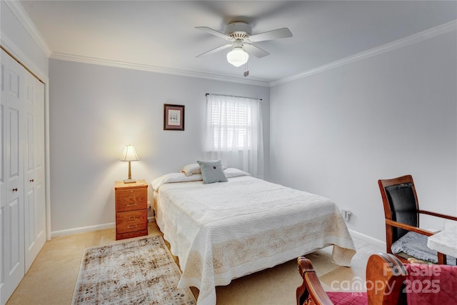 bedroom featuring light carpet, crown molding, baseboards, and a closet