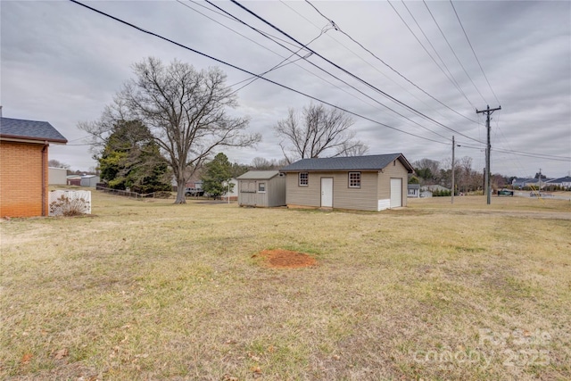 view of yard featuring an outbuilding and a garage