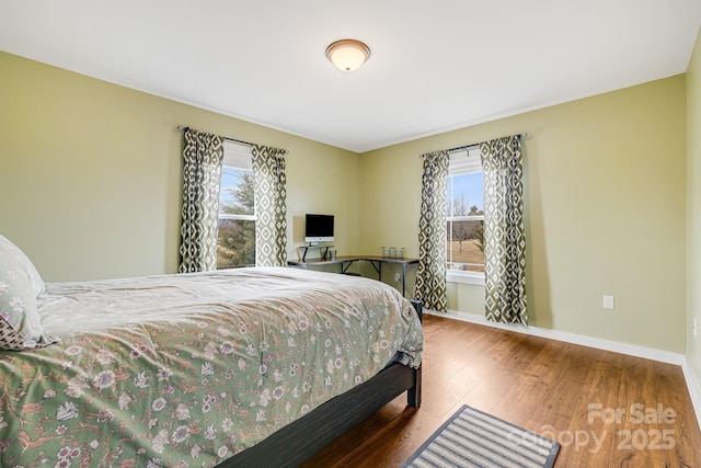 bedroom with hardwood / wood-style flooring