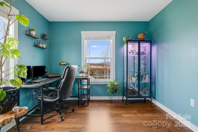 home office with wood-type flooring