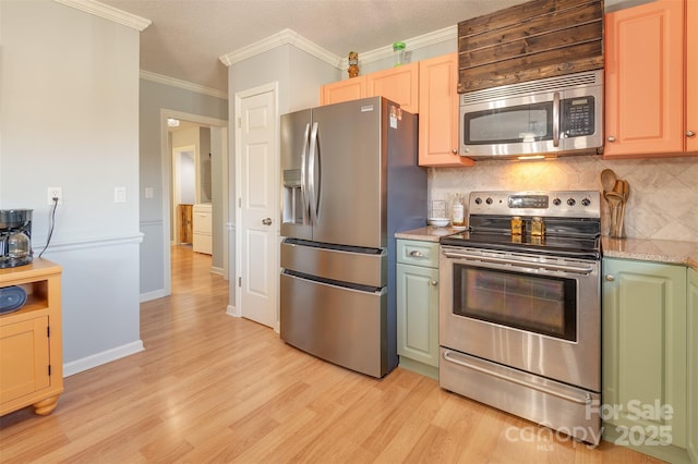 kitchen featuring backsplash, crown molding, light wood-type flooring, and appliances with stainless steel finishes