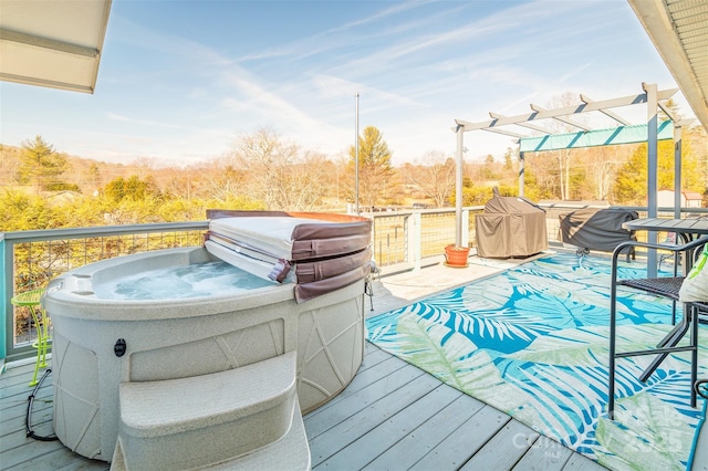 wooden deck with a hot tub and a pergola