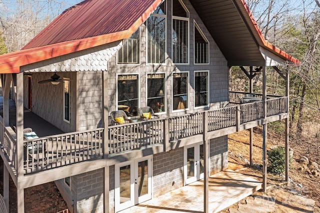 view of property exterior featuring metal roof and french doors