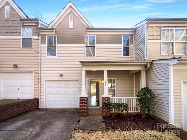 multi unit property with a garage and covered porch