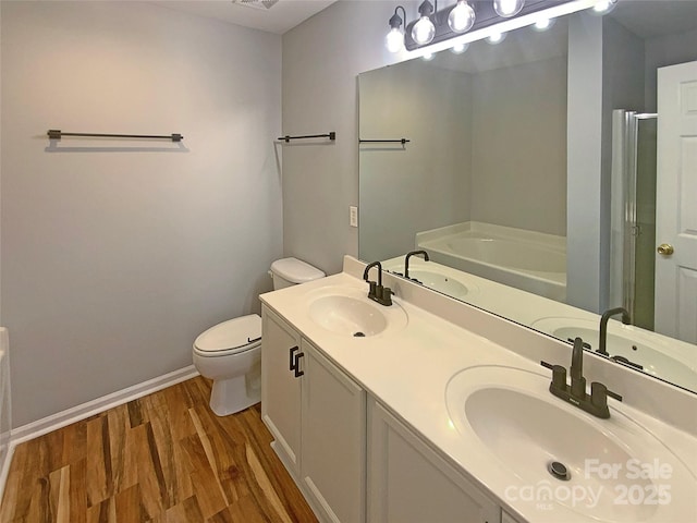 full bathroom featuring wood-type flooring, shower with separate bathtub, vanity, and toilet