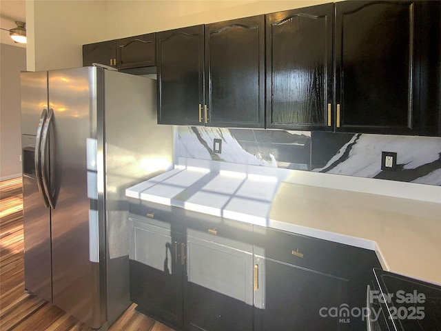 kitchen with tasteful backsplash, wood-type flooring, and stainless steel fridge with ice dispenser