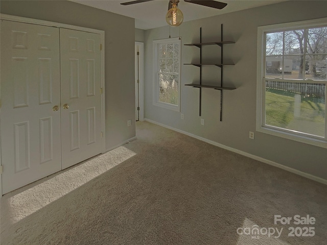 interior space featuring a closet, ceiling fan, and carpet flooring