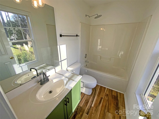 full bathroom featuring shower / tub combination, vanity, toilet, and hardwood / wood-style floors