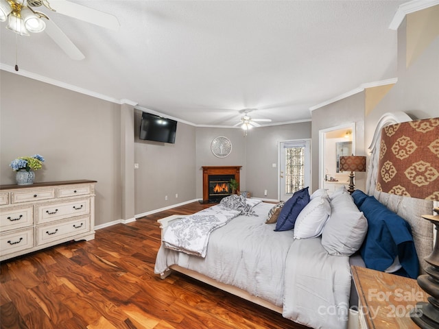 bedroom with dark wood-type flooring, ceiling fan, connected bathroom, and crown molding