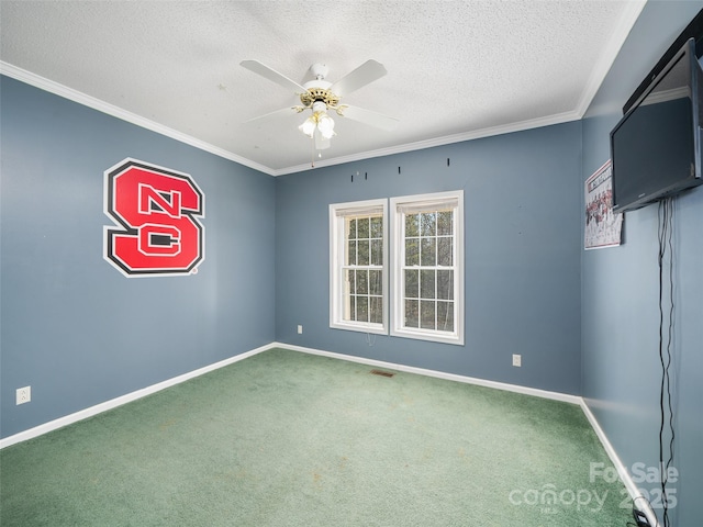 empty room featuring ceiling fan, ornamental molding, carpet floors, and a textured ceiling