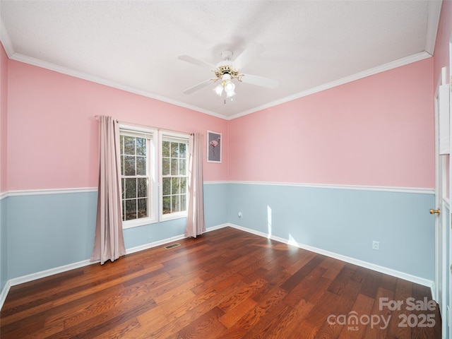 unfurnished room featuring ceiling fan, ornamental molding, and dark hardwood / wood-style flooring