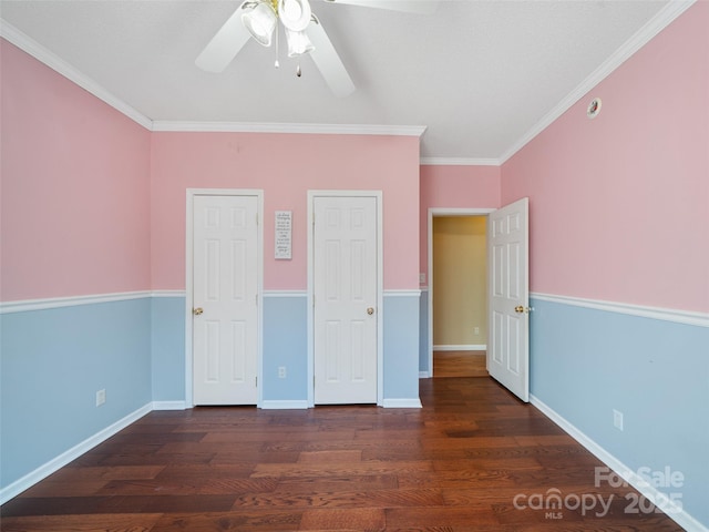 unfurnished bedroom with ornamental molding, dark hardwood / wood-style floors, and ceiling fan