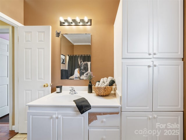 bathroom with ornamental molding and vanity