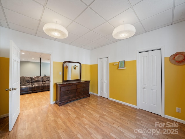 spare room featuring a drop ceiling and hardwood / wood-style flooring