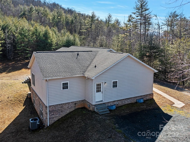 back of house featuring cooling unit