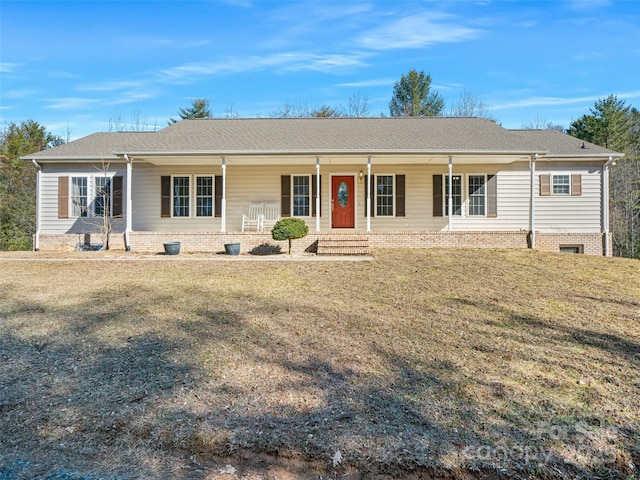 ranch-style home featuring a front yard and covered porch