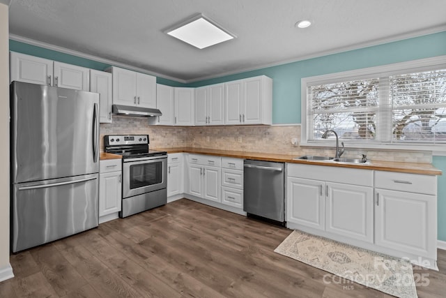 kitchen with sink, crown molding, white cabinets, and appliances with stainless steel finishes