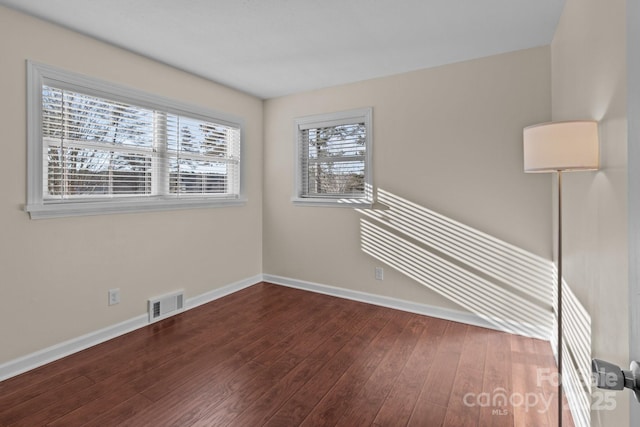 spare room with dark hardwood / wood-style flooring