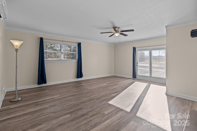 empty room with hardwood / wood-style flooring, a wealth of natural light, ornamental molding, and ceiling fan