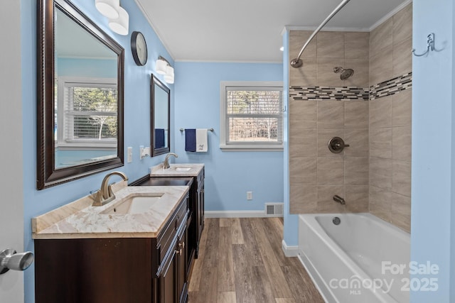 bathroom with ornamental molding, hardwood / wood-style floors, vanity, and a wealth of natural light