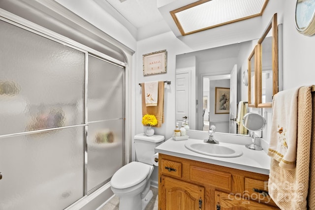 bathroom with vanity, an enclosed shower, and toilet