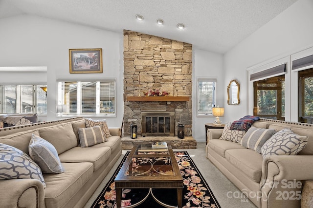 living room with a fireplace, carpet floors, a textured ceiling, and vaulted ceiling