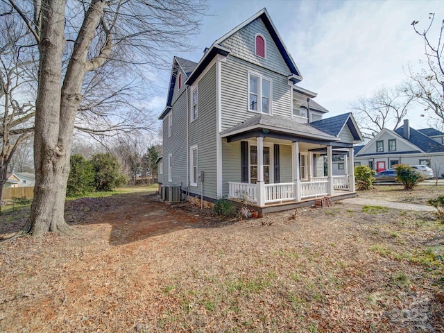 victorian home featuring cooling unit and covered porch