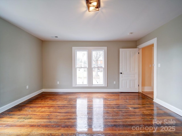 spare room featuring wood-type flooring