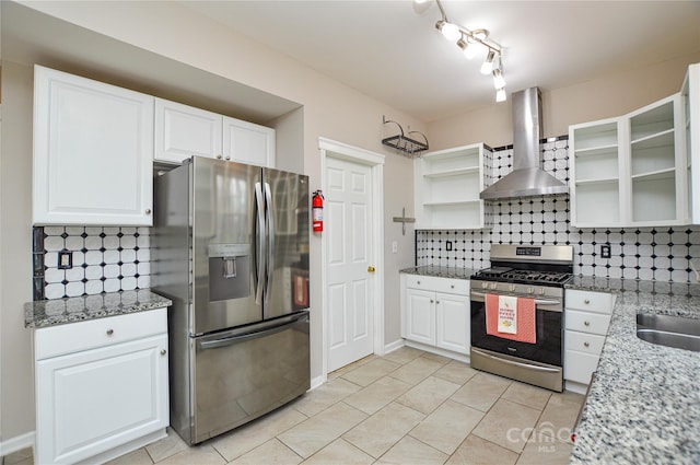 kitchen featuring open shelves, tasteful backsplash, stainless steel appliances, wall chimney exhaust hood, and white cabinets