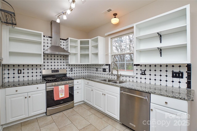 kitchen with visible vents, open shelves, a sink, appliances with stainless steel finishes, and wall chimney exhaust hood