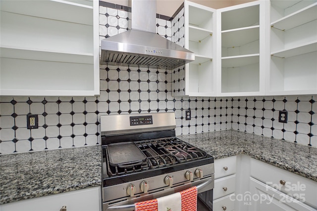 kitchen featuring open shelves, decorative backsplash, stainless steel gas stove, and wall chimney exhaust hood