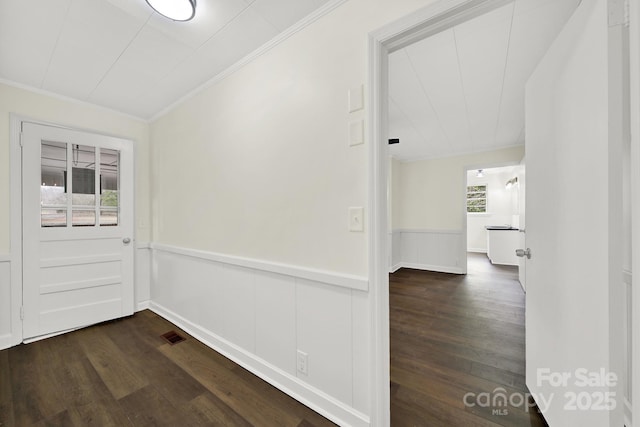 interior space featuring ornamental molding and dark hardwood / wood-style floors