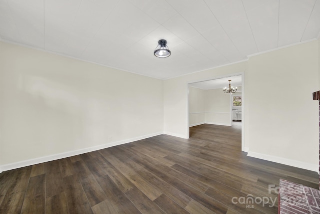 unfurnished room featuring ornamental molding, dark hardwood / wood-style flooring, and a chandelier