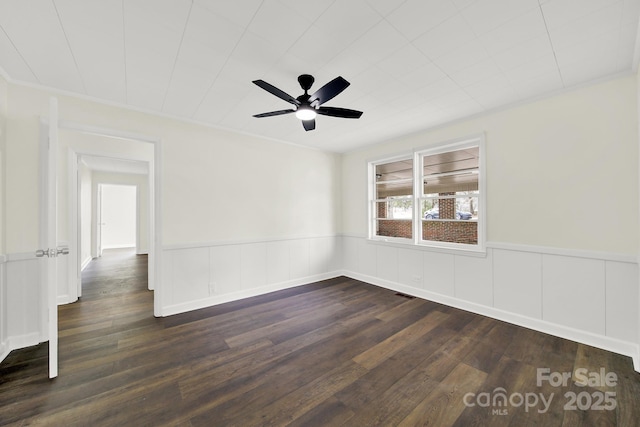 empty room with dark wood-type flooring and ceiling fan