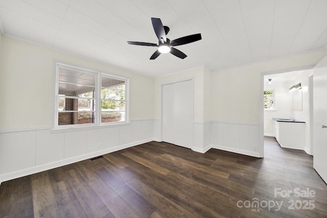 empty room featuring dark hardwood / wood-style flooring and ceiling fan