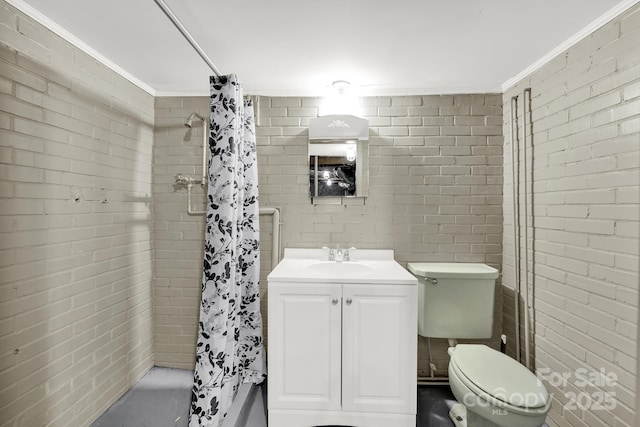 bathroom featuring brick wall, toilet, vanity, walk in shower, and crown molding