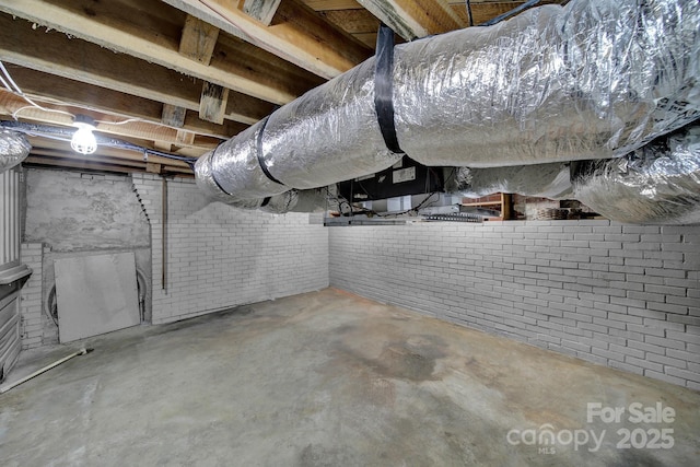 basement featuring brick wall