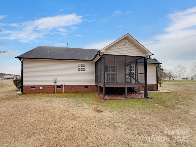 back of property with a yard and a sunroom