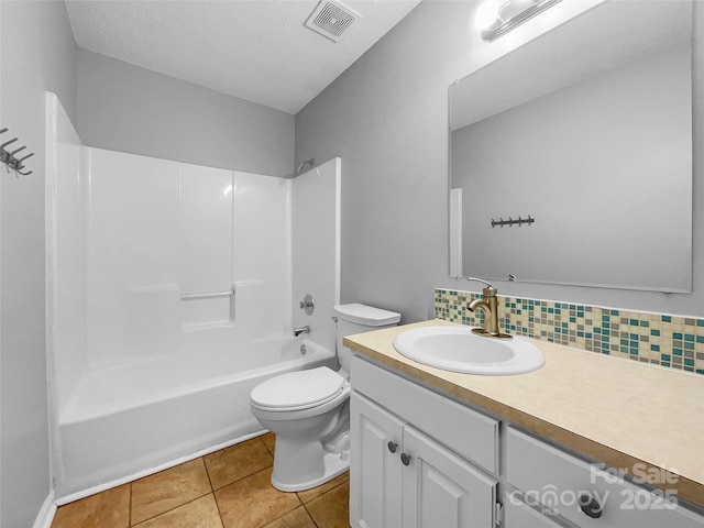 full bathroom with washtub / shower combination, toilet, tasteful backsplash, vanity, and tile patterned flooring