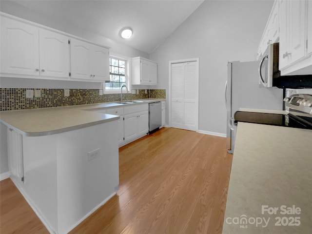 kitchen featuring sink, white cabinets, kitchen peninsula, stainless steel appliances, and light hardwood / wood-style flooring