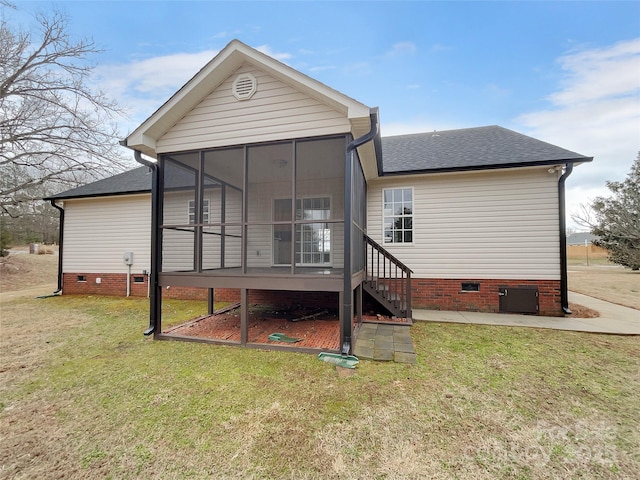 rear view of house with a yard and a sunroom