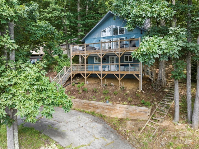 rear view of property featuring a wooden deck