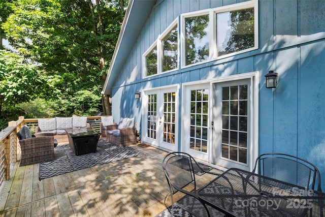 wooden terrace featuring an outdoor living space and french doors