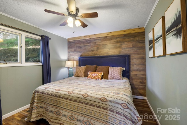 bedroom with dark wood-type flooring, wooden walls, and crown molding