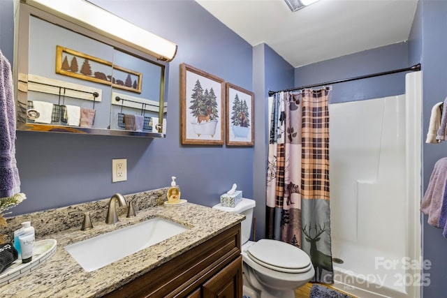 bathroom featuring vanity, a shower with curtain, and toilet