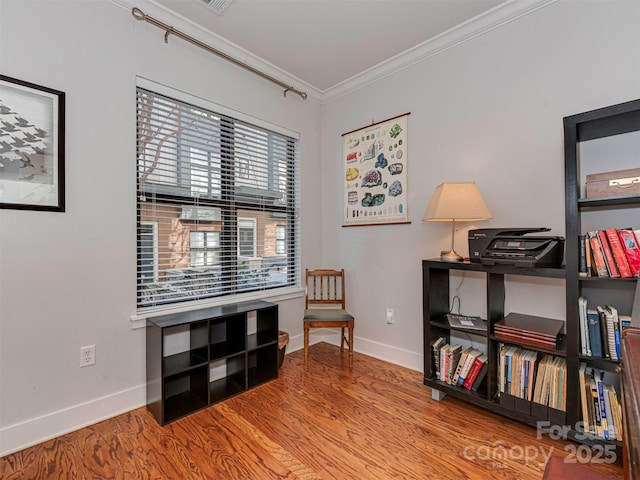 living area featuring crown molding and hardwood / wood-style floors