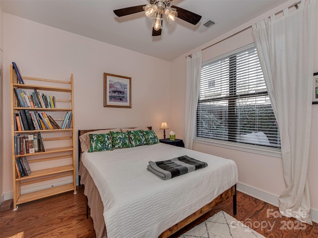 bedroom featuring ceiling fan and dark hardwood / wood-style floors