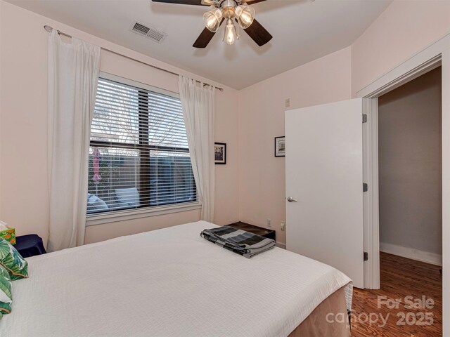 bedroom with hardwood / wood-style flooring and ceiling fan