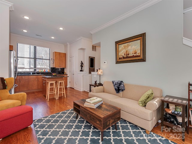 living room featuring hardwood / wood-style floors and crown molding