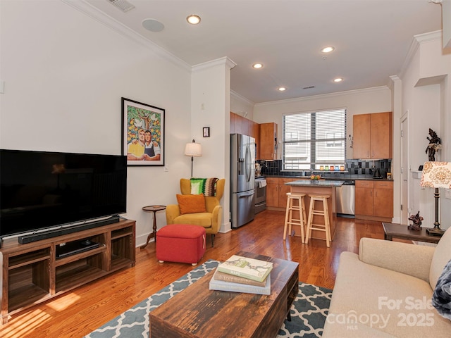 living room featuring crown molding and dark hardwood / wood-style flooring